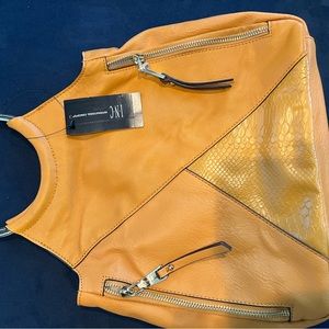 Leather mustard bag, with snake pattern in the middle.